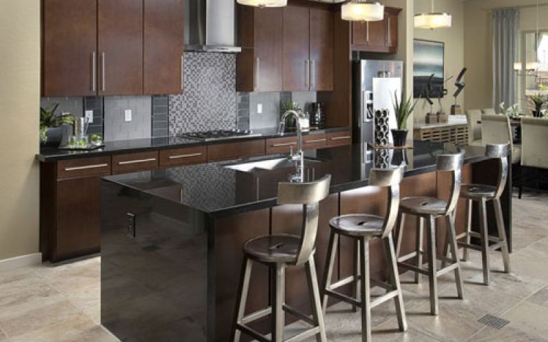 Kitchen after remodeling with resurfaced cabinets and tile floors.